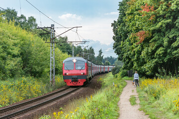 Fototapeta premium Passenger train moves at autumn day time.