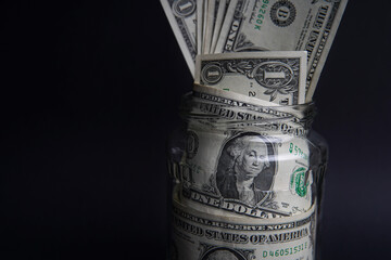 American dollars in the glass jar, you can save money. Easy ways to save real money. Black...
