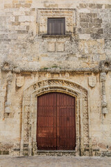 Fototapeta na wymiar Gate of the Casa del Cordon, the oldest stone building in America, in Santo Domingo, capital of Dominican Republic.