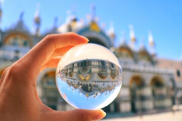 hand holding globe or lens ball in little Venice 