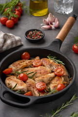 Grilled chicken breast or fillet with tomato on iron pan.