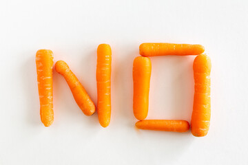 No spelled with orange carrots on white background, food, conceptual, say no