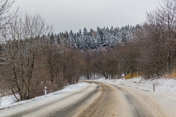 Obraz premium Winter view of I/11 road near Suchy vrch mountain, Czech Republic