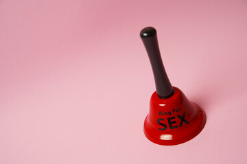 Red bell with sex inscription. Bell ringing for erotic toys. Concept of sex and erotica. For...