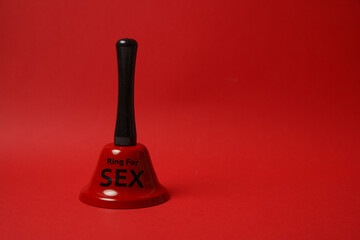 Red bell with sex inscription. Bell ringing for erotic toys. Concept of sex and erotica. For...