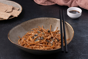 Root paste, with soy sauce, with chopsticks. Horizontal orientation.