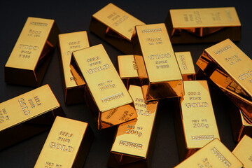 Scattered gold bars on the black table. Shiny precious metals for investments or reserves. Bank image and photo.