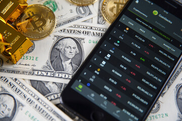 Smartphone application. CoinGecko logo on phone screen close up. On the table in the background...
