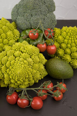 Healthy vegetarian food, fresh green food, green vegetable, romanesco broccoli, pepper, zucchini, avocado, cherry tomato