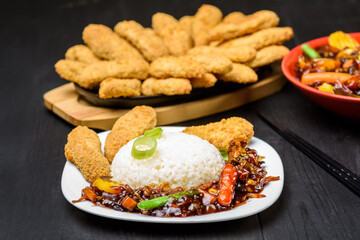 rice with vegetables in sweet and sour sauce and chicken tenderloin