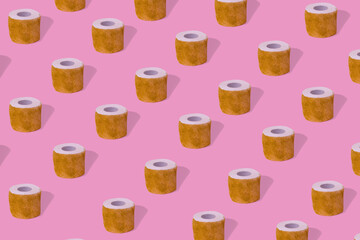 Creative idea with toilet paper with glitter, pattern on a pastel pink background