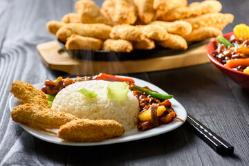 rice with vegetables in sweet and sour sauce and chicken tenderloin