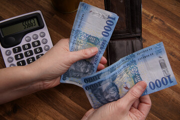Woman hand holding cash Hungarian forint banknotes, business calculations and expenses, business...