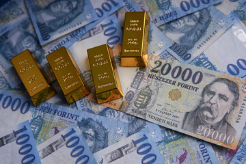 Several Hungarian forint paper money denominations on a blue background. Bank image and photo.