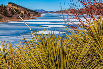 Frozen mountain reservoir in winter on a sunny day