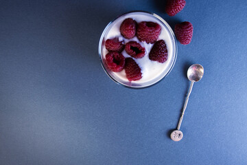 Glass with yogurt and raspberries