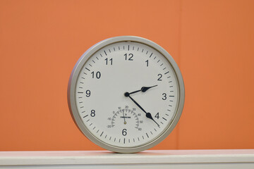 Round clock against orange background