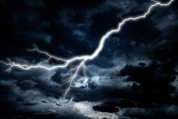 Naklejka na ściany i meble Lightning strike against the background of a cloudy dark sky.