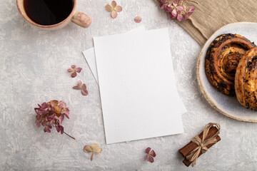 White paper invitation card, mockup with , bun, hydrangea flowers, bun, cup of coffee, linen...
