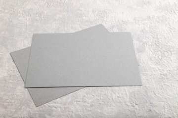 Gray paper business card, mockup on gray concrete background. Blank, flat lay, top view