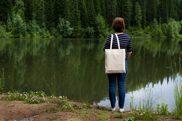Woman carrying tote bag on the lake shore, mockup