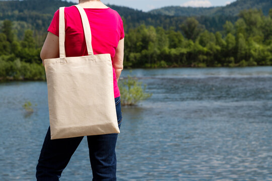 Woman In Red Tee Holding Tote Bag Mockup