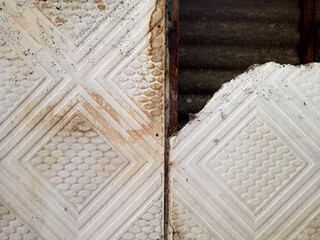 the roof of the old house with holes due to eroded age