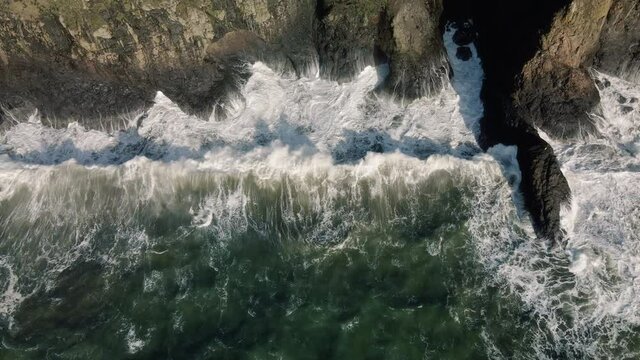 Slow Motion Aerial of King Tide Wave Slamming Rock Cliff of Coastal Shore