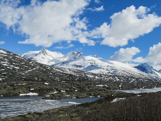 View of snow capped mountains peak with blue sky background in Skagway, Alaska