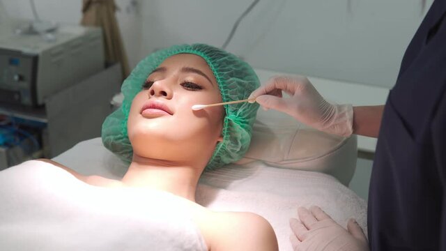 Botox,Collagen injections prepare. B Roll of Beauty clinic business concept. Beautician hands in gloves preparing botox injection in a face skin. Asian woman gets beauty facial cosmetology procedure.