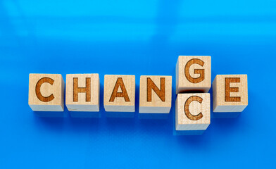 Top view of wooden cubes with word `change` to `chance` on blue background. Concept: Personal development and career, growth or change yourself and motivation. 