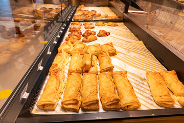 Variety of baked products at a supermarket. Display of a bakery there is a wide variety of baked...