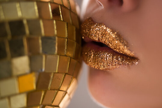 Golden lips. Gold metal lip. Beautiful makeup. Sexy bright lipgloss.