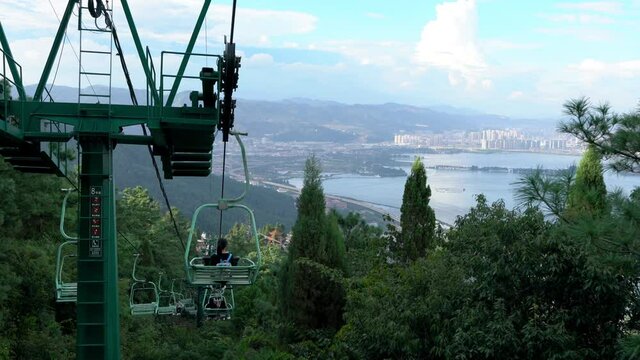 Chairlift ride over west hill or Xishan forest park and city view in Kunming Yunnan China