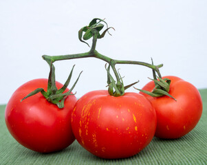 red tomatoes with green branches for salad.
