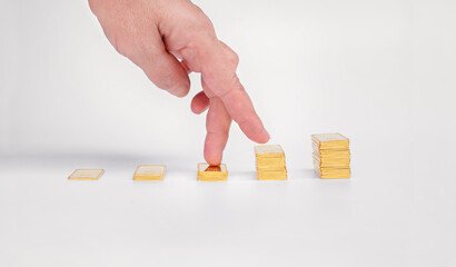 Women's fingers climb the ladder of gold bars