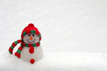 cute snowman ornament on white snow background with copy space