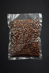 fresh roasted coffee beans packed in vacuum sealed bag, gray background