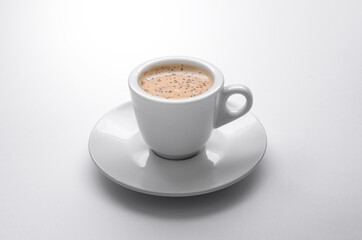 Aromatic coffee drink in white cup on white background