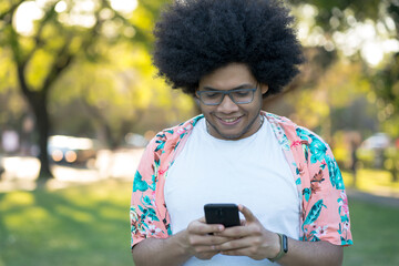 Latin man using his mobile phone outdoors.