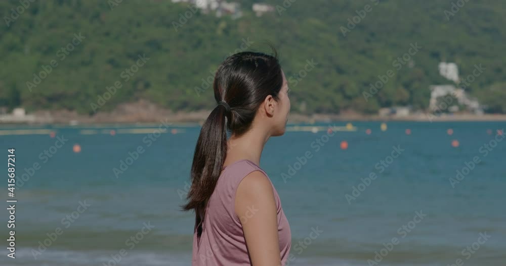 Wall mural woman look at the sea beach