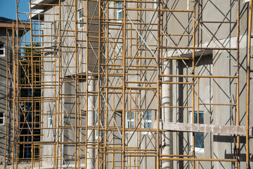 A scaffold tower outside the wall of a construction project