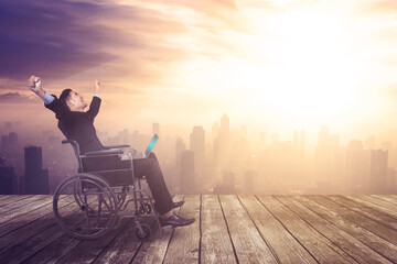 Disabled businessman celebrates success on rooftop