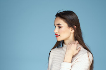 Fototapeta premium Brunette in white sweater red lips charm cropped view blue background