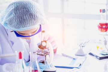 Female scientist look at microscope, science test tube analyse scientific sample in laboratory...