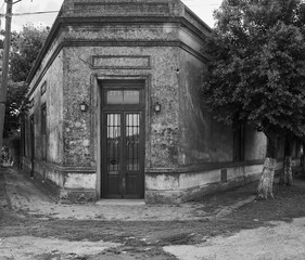Fototapeta premium Corner with old country house with brick front door and window in black and white