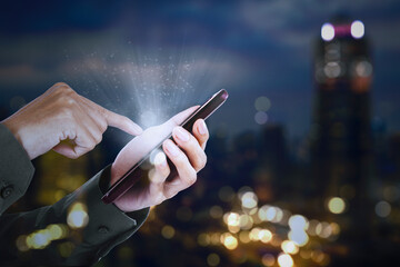 Businessman hands touching a bright phone screen