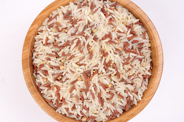 Mixed low glycaemic index healthy rice grain basmati millet buckwheat red rice in wooden bowl on white background top view