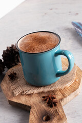 blue cup with chocolate drink and cinnamon
