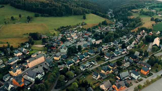german town of Seiffen extending between high green hills, Aerial view